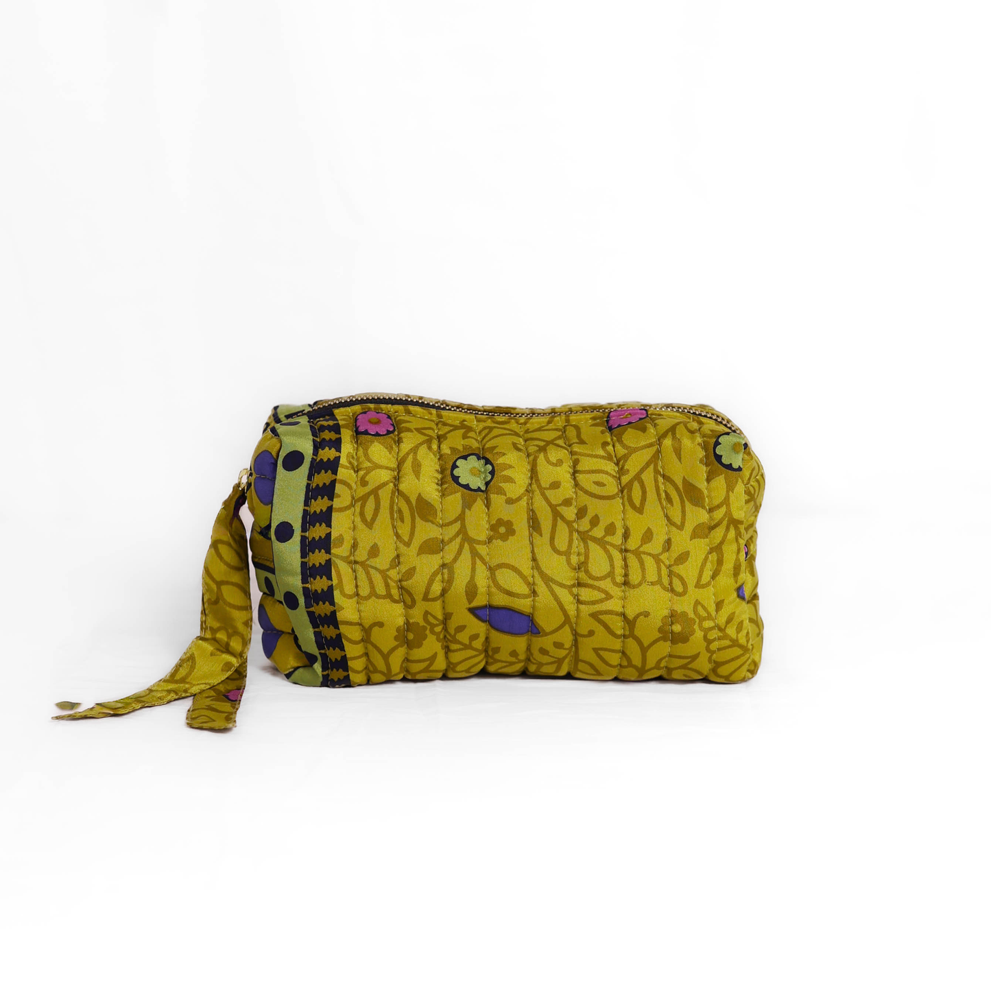 Quilted dumpling bag made from repurposed vintage sari fabric with stitched detailing and a structured rectangular shape. The bag features a zip closure and a fabric tie