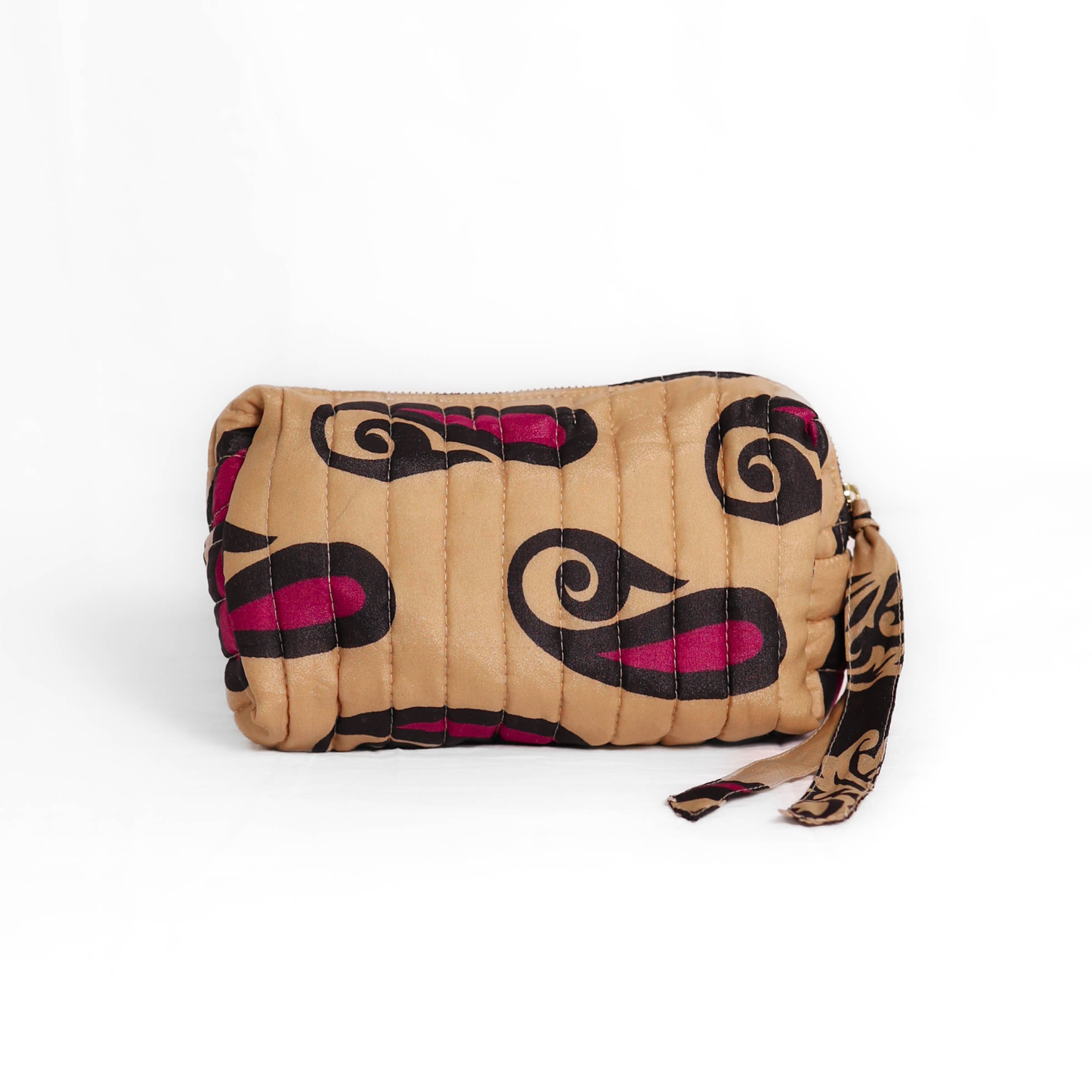 Quilted dumpling bag made from repurposed vintage sari fabric with stitched detailing and a structured rectangular shape. The bag features a zip closure and a fabric tie