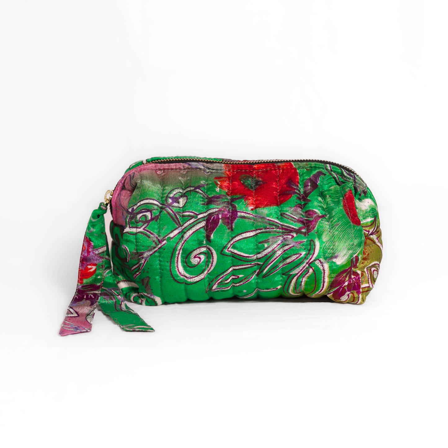 Quilted dumpling bag made from repurposed vintage sari fabric with stitched detailing and a structured rectangular shape. The bag features a zip closure and a fabric tie