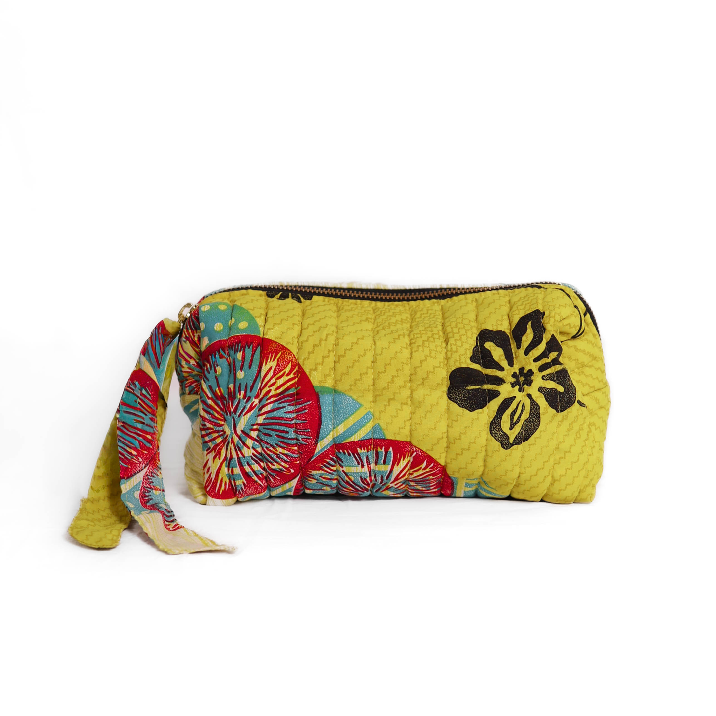 Quilted dumpling bag made from repurposed vintage sari fabric with stitched detailing and a structured rectangular shape. The bag features a zip closure and a fabric tie