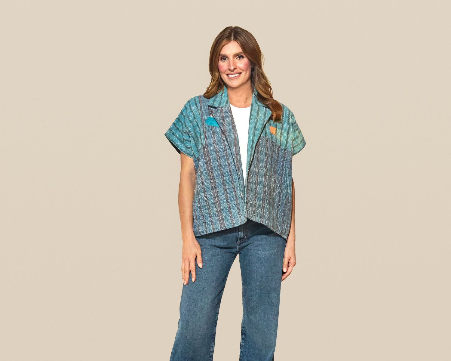 Short-sleeve open-front jacket made from a teal woven textile with vertical stripe patterns and subtle geometric detailing.