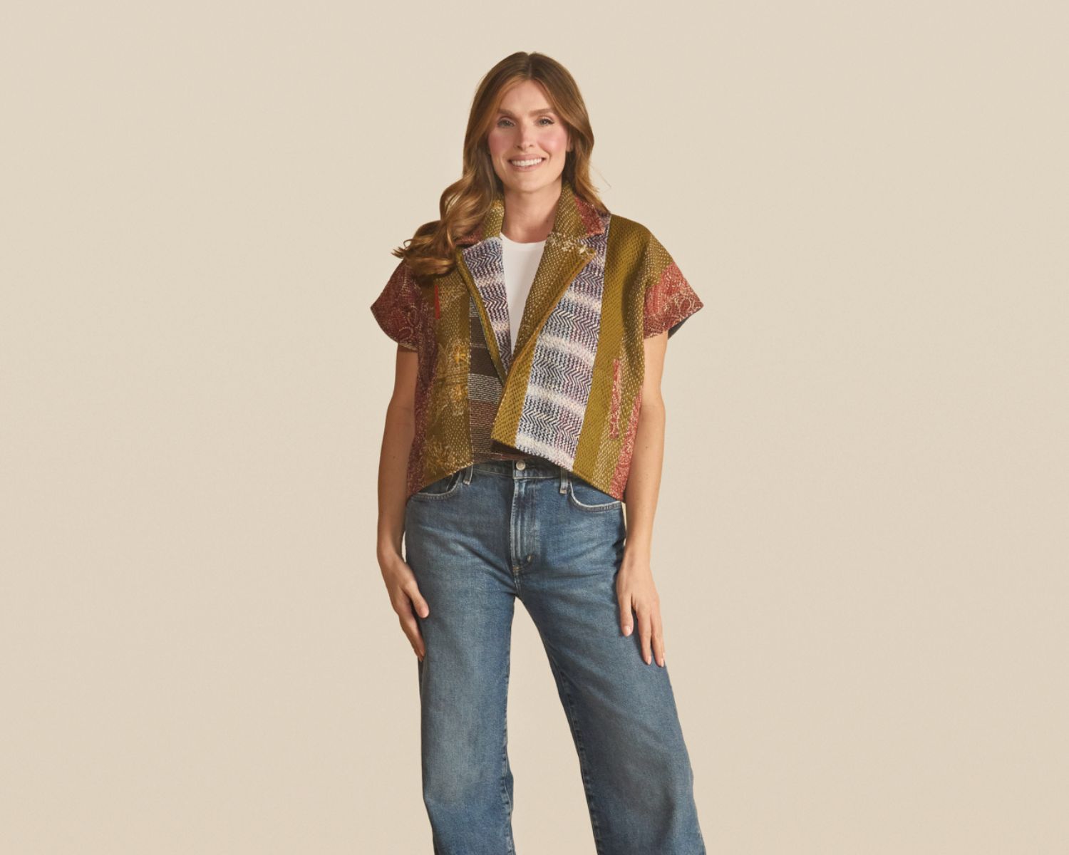 Short-sleeve open-front jacket made from multicolored woven textiles in olive, rust, and cream with mixed stripe and geometric patterns.