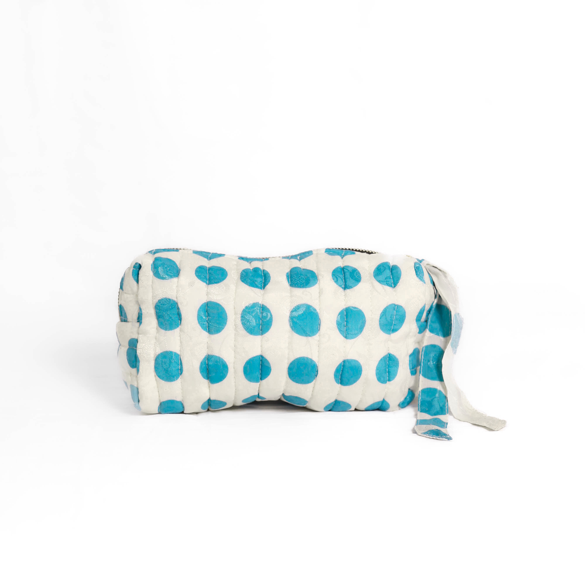 Quilted dumpling bag made from repurposed vintage sari fabric with stitched detailing and a structured rectangular shape. The bag features a zip closure and a fabric tie
