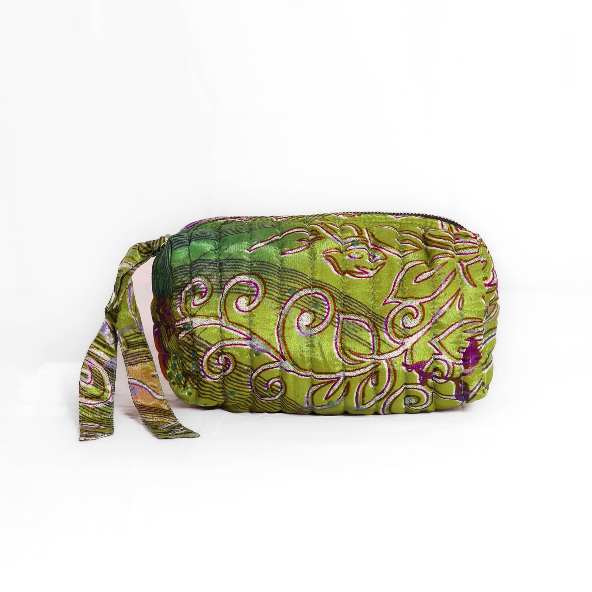 Quilted dumpling bag made from repurposed vintage sari fabric with stitched detailing and a structured rectangular shape. The bag features a zip closure and a fabric tie