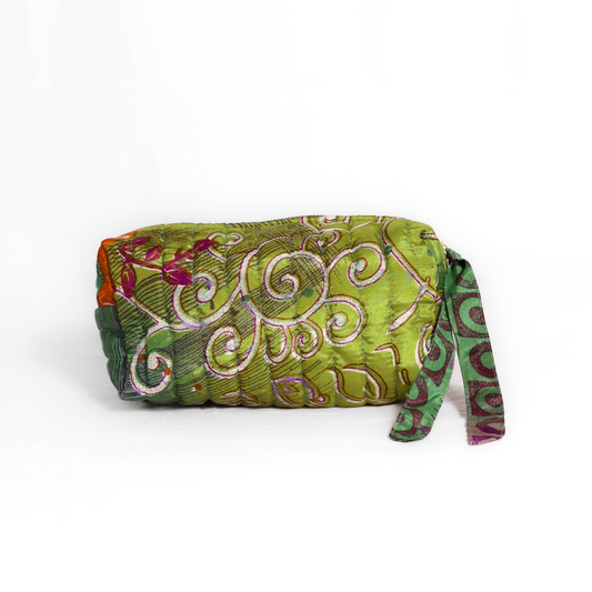 Quilted dumpling bag made from repurposed vintage sari fabric with stitched detailing and a structured rectangular shape. The bag features a zip closure and a fabric tie