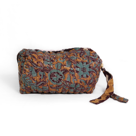 Quilted dumpling bag made from repurposed vintage sari fabric with stitched detailing and a structured rectangular shape. The bag features a zip closure and a fabric tie