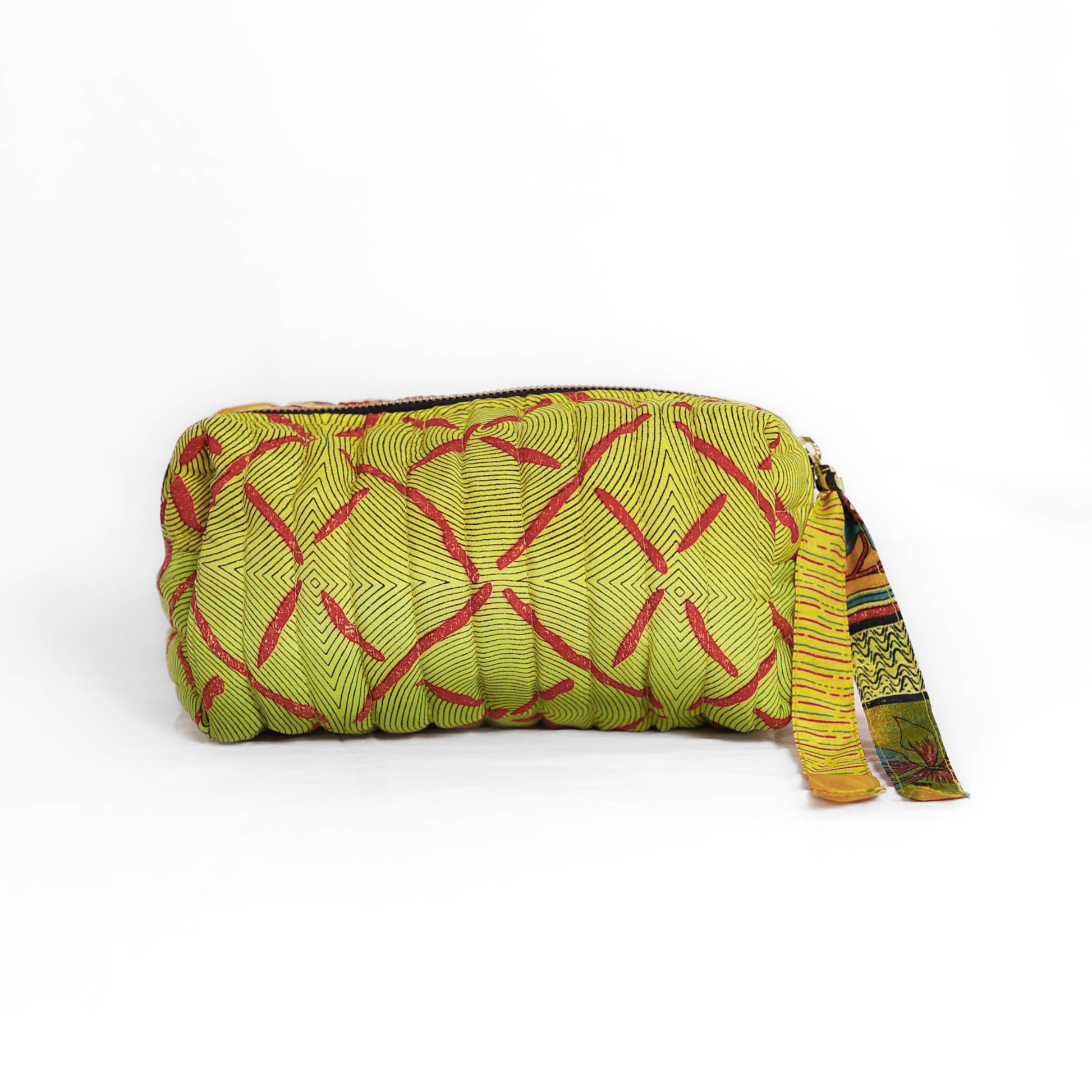 Quilted dumpling bag made from repurposed vintage sari fabric with stitched detailing and a structured rectangular shape. The bag features a zip closure and a fabric tie