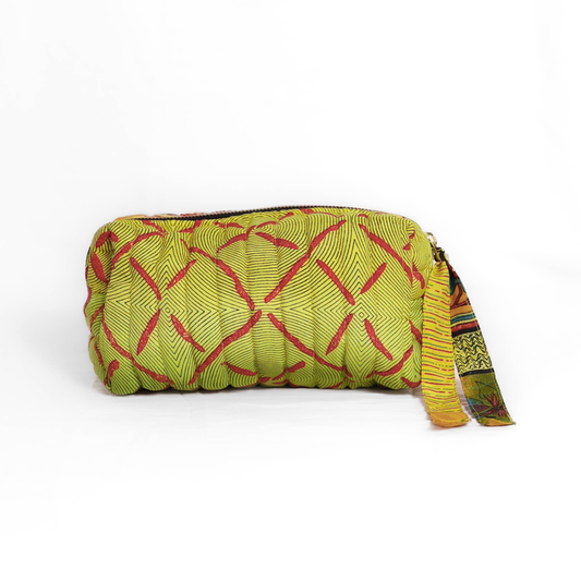 Quilted dumpling bag made from repurposed vintage sari fabric with stitched detailing and a structured rectangular shape. The bag features a zip closure and a fabric tie