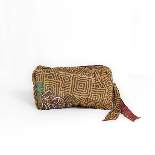 Quilted dumpling bag made from repurposed vintage sari fabric with stitched detailing and a structured rectangular shape. The bag features a zip closure and a fabric tie
